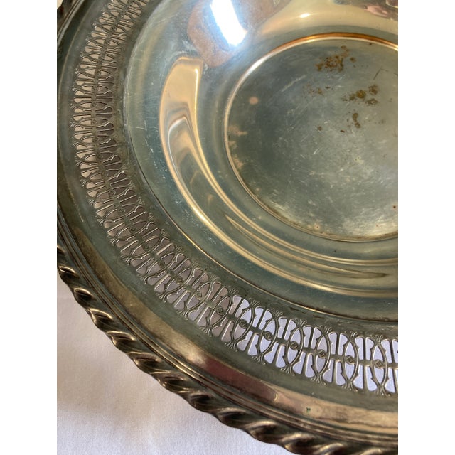 A very pretty bowl or cachepot with decorative edges that are cut out in a woven pattern. Very nice with vintage patina.