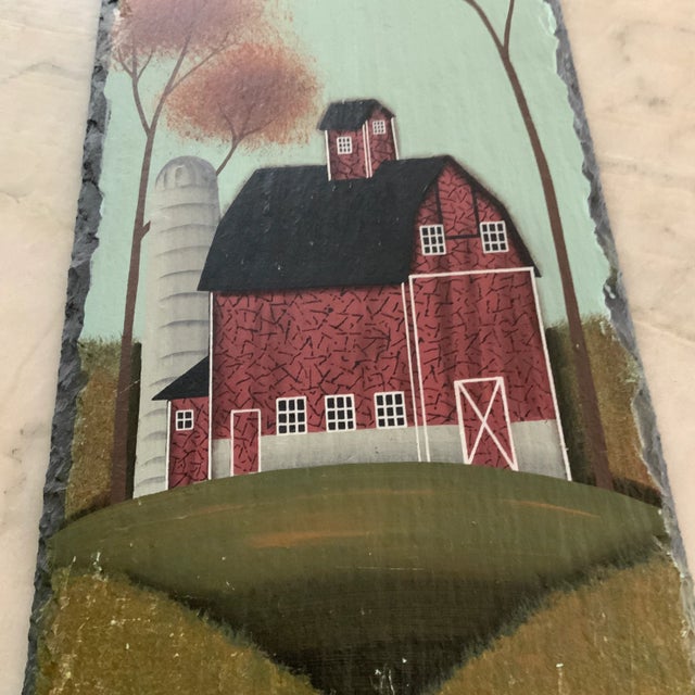 Great rendering of a rustic old red barn on a nicely weighted piece of grey slate. Could be suspended on a wall by the...