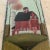 Great rendering of a rustic old red barn on a nicely weighted piece of grey slate. Could be suspended on a wall by the...