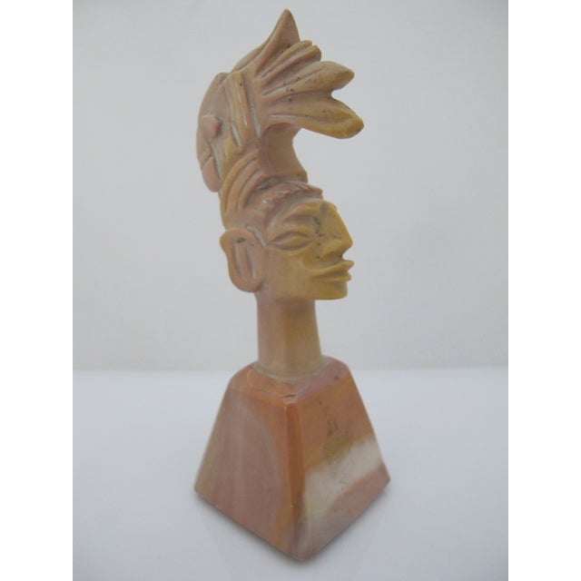 Carved Aztec Mayan Indian chief in headdress figurine. Polished stone in multi-tones of pink, tan, and cream. Measures 5"...