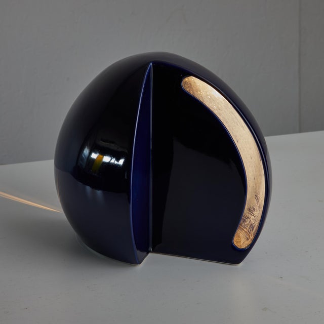 This exquisite deep blue ceramic lamp, crafted in the elegant shape of a hemisphere, is more than just a source of...