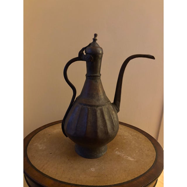 Enhance your collection of Persian Metal Work with this early to mid century Aftabbah Erwe. This vessel had been a fixture...