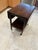 This wheeled tea trolley or pembroke table is believed to be made of mahogany with a walnut burl veneer top, a lower...