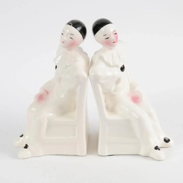 Ceramic bookends shaped like sitting Pierrots. Made in Netherlands in 1970s, probably by Royal Delft.
