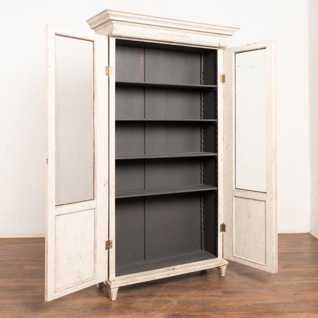 Late 19th-century Swedish Gustavian-style two-door pine bookcase with newer professionally applied antique white painted...