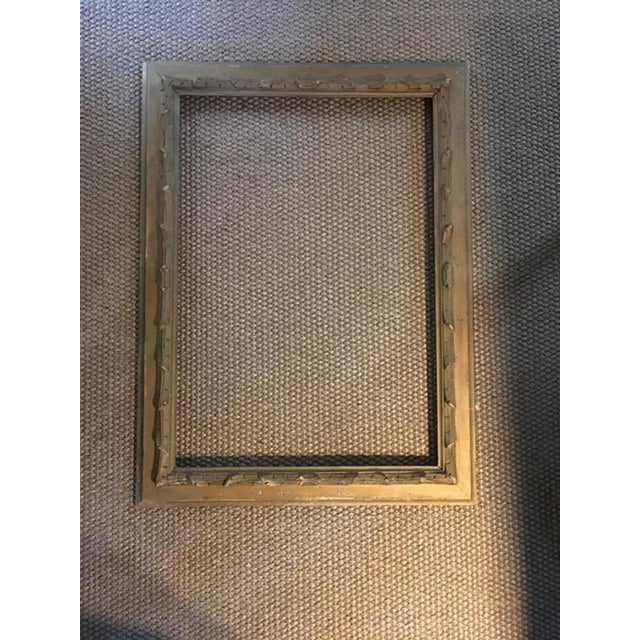 This is an elegant wood frame, lacquered in mat gold. The thick hand carved border also is lacquered in gold. The frame...