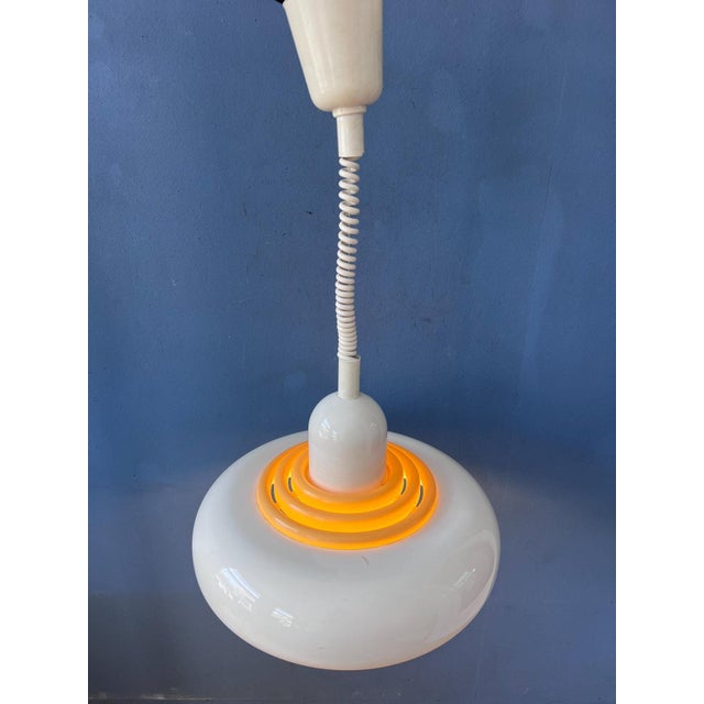 Mid-century beige UFO hanging lamp by Knud Christensen featuring a sleek Scandinavian design and layered shade...