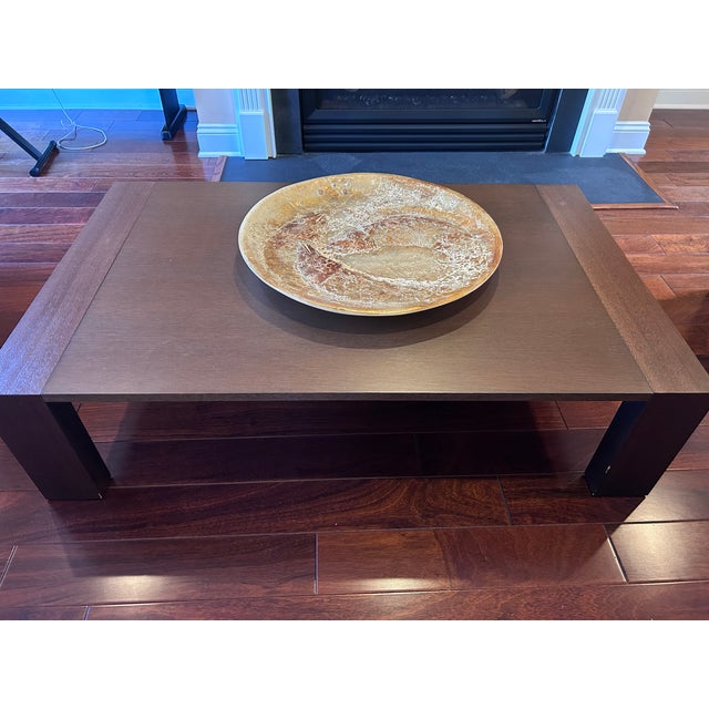 Sleek, architectural coffee table sourced from a high-end contemporary retailer in Ottawa and crafted in Italy. This piece...