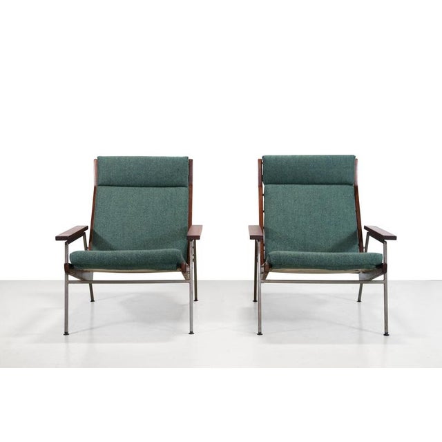 A set of two armchairs designed by Rob Parry for Gelderland. The model, called Lotus, features a steel base, solid teak...