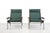 A set of two armchairs designed by Rob Parry for Gelderland. The model, called Lotus, features a steel base, solid teak...