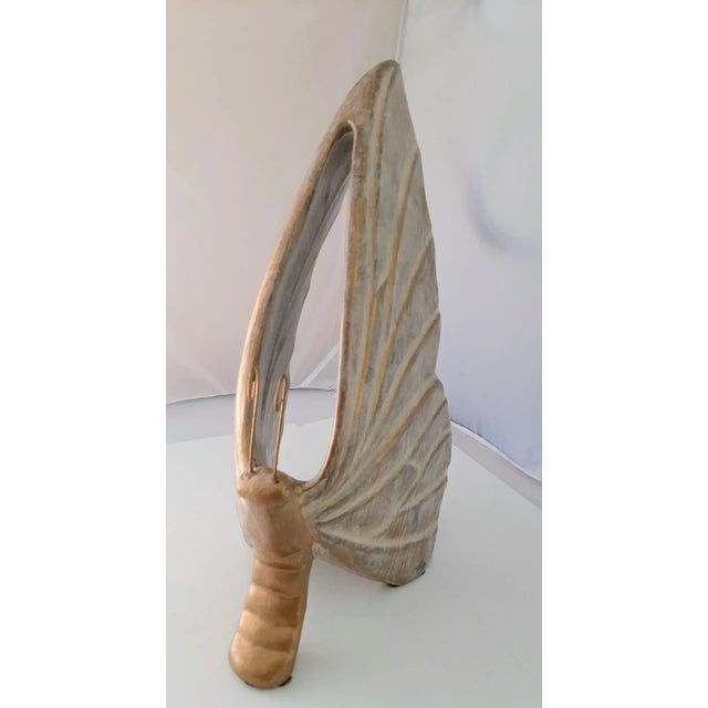 Captivating gold butterfly, beautifully crafted from painted ceramic and exuding a charming weightiness that speaks to its...