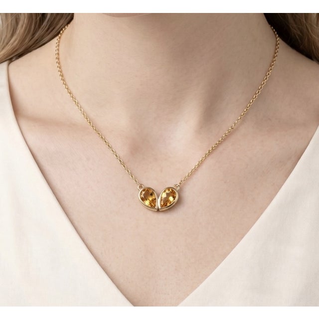 Celebrate timeless elegance with this beautifully crafted double pear gemstone necklace, designed to symbolize connection,...