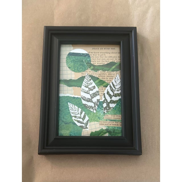 An original mixed-media collage featuring layered painted papers, vintage book text, graph paper, and hand-cut botanical...