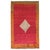 Turkish Tulu Bedding rug with an off center gray medallion set on a plain cherry red field and pumpkin orange border....