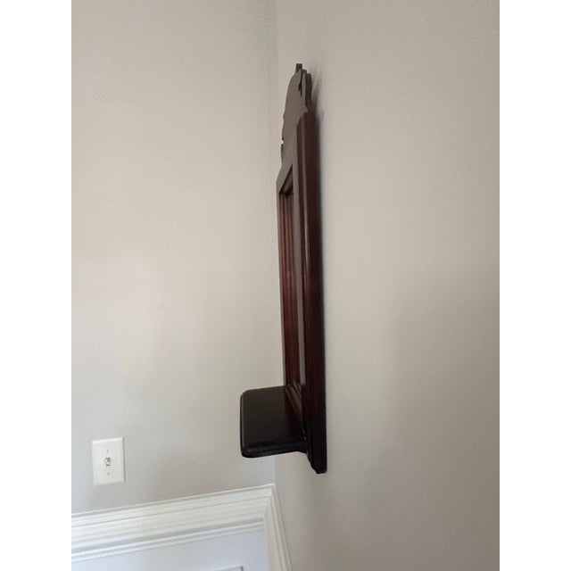 Small rectangular wall mirror with scallop shell inlay on top. Carved top. Tiny shelf on bottom.