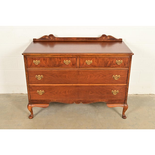 A gorgeous antique Queen Anne or Victorian style four-drawer dresser or chest of drawers By Berkey & Gay USA, Circa 1920s...