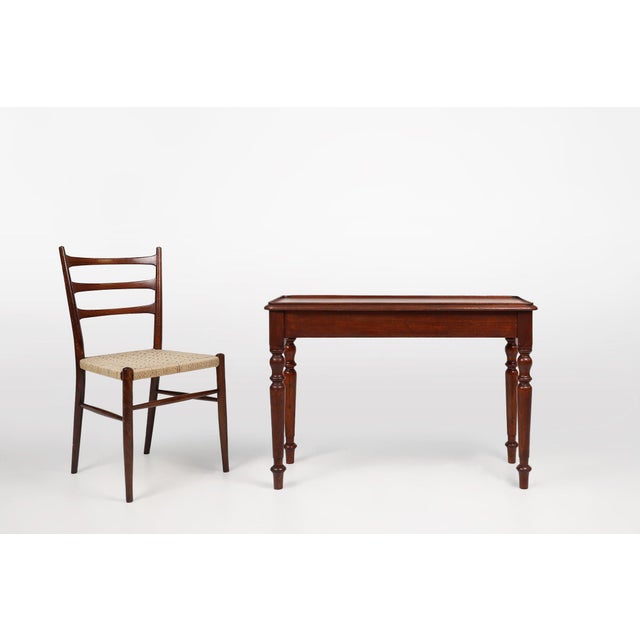 A refined British side table from circa 1850, crafted in solid wood and shaped with the elegant restraint characteristic...