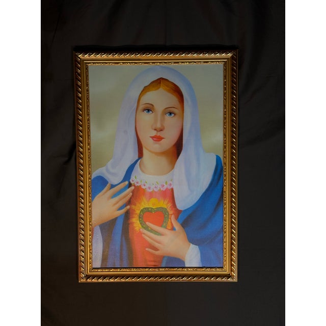 Framed religious portrait artwork featuring a classic devotional Sacred Heart style image with vivid blue, white, red, and...
