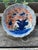 A charming antique Japanese porcelain bowl featuring a beautifully scalloped form and hand-painted decoration in rich...