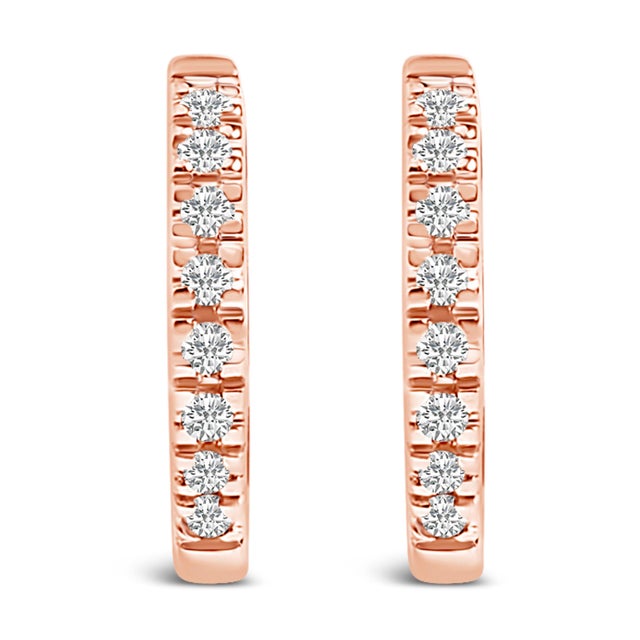 Immerse yourself in the understated elegance of these 14K Rose Gold huggie hoop earrings, each piece glistening with...
