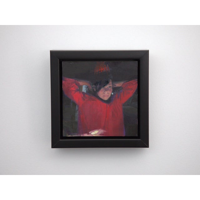 In "The Big Mirror 1," a figure in a striking red garment is captured in a moment of introspection, with her hands raised...