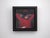 In "The Big Mirror 1," a figure in a striking red garment is captured in a moment of introspection, with her hands raised...