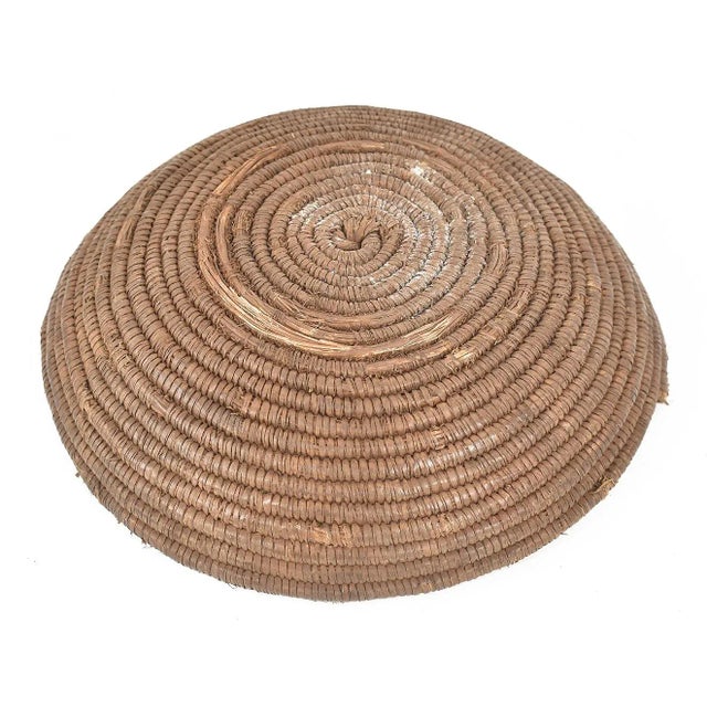 An old woven bowl made by the Hausa people of Nigeria. The tight weave of the vessel indicates its age. Every basket is...