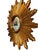 French wood starburst mirror, a striking decorative wall piece with radiating carved wood rays and a warm aged finish. The...