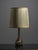 This vintage table lamp from the 1960s–1970s features a multicolored hand-blown glass base paired with a warm-toned...