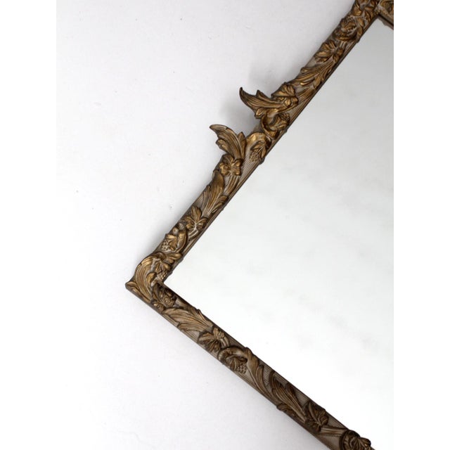 Louis XV style gilt wall mirror with an ornate composition frame, richly detailed with scrolling acanthus leaves and...