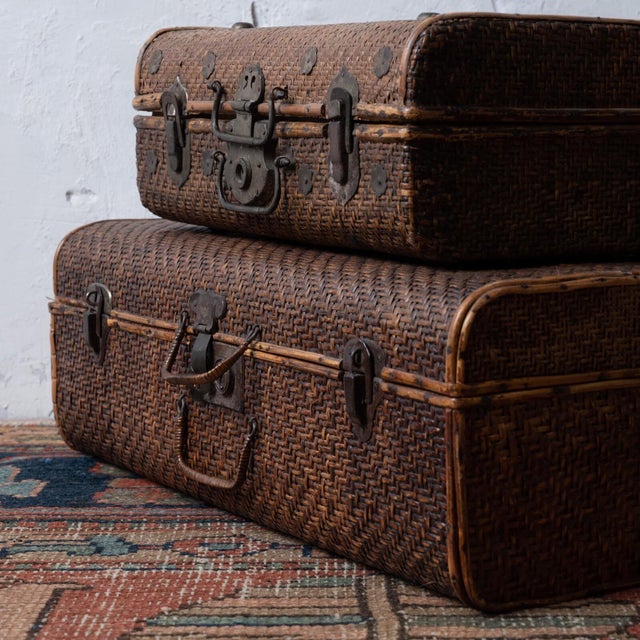 A pair of vintage rattan suitcases, Thailand, circa 1950s. Larger measures 22 ¼ inches wide by 13 inches deep by 7 ½...
