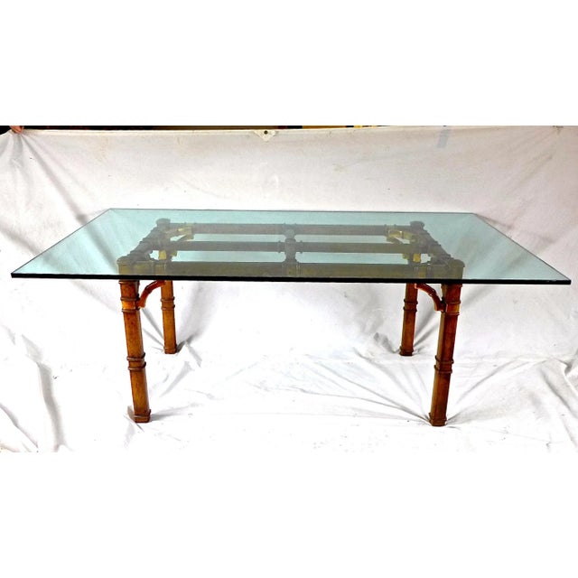 Hollywood Regency faux-bamboo glass-top dining table, seats a comfortable eight people. Brass entwined shoulder buckles to...