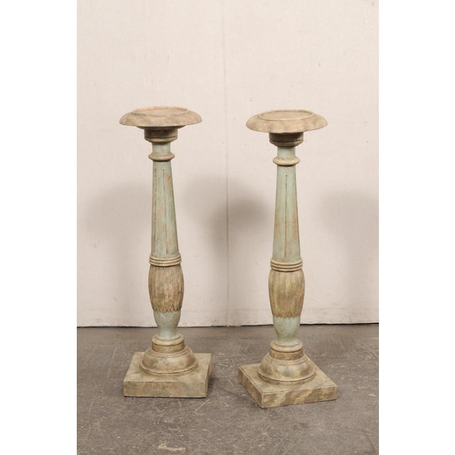 A Swedish Gustavian pair of carved and painted wood display pedestals from the turn of the 18th and 19th century. These...