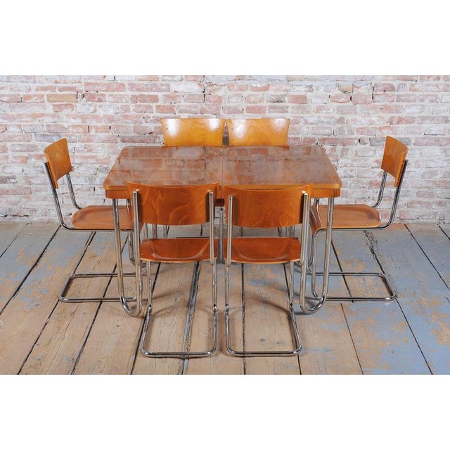 Adjustable width: 120 cm - 170 cm (47 in - 67 in) This early 20th-century dining table sits at the intersection of Art...