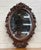 This is an ornate hand-carved vintage Victorian Revival wall mirror featuring rich grape and vine motifs in solid...