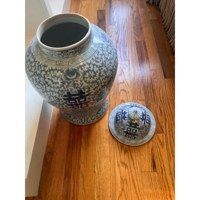 This blue and white porcelain ginger jar features the traditional Chinese "Double Happiness" character (Shuangxi) a...