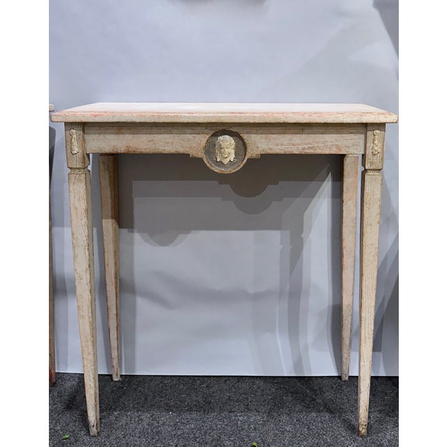 A striking pair of Swedish console tables, circa 1880, with the restrained neoclassical design associated with Gustavian...