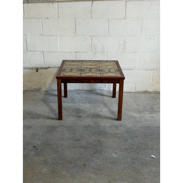 Beautiful Danish Modern side table crafted in richly grained rosewood with an eye-catching ceramic tile top. Made in...