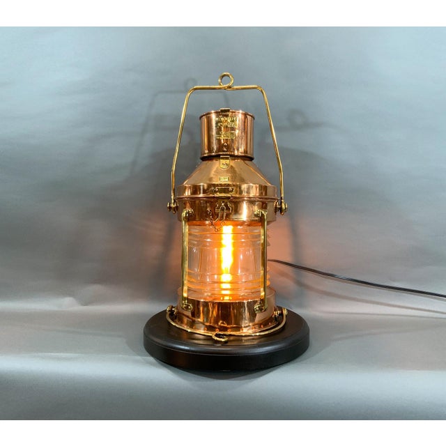 Highly polished and lacquered solid copper ship’s lantern with lacquer finish. Fresnel glass lens. Wired with electric...