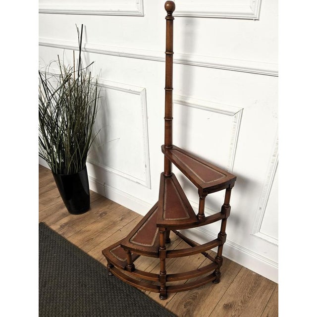 Beautiful Italian carved walnut wood circular step ladder with four stairs rolled around a turned, central pole with a...