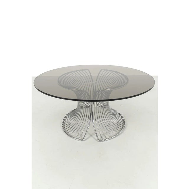 Wonderful Vintage Coffee Table Made of A Chrome Wireframe Base with Smoke Glass Top. In good vintage condition....