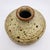 Hand-thrown stoneware weed pot with squat shouldered form, speckled cream glaze with iron-oxide spotting, unglazed brown...
