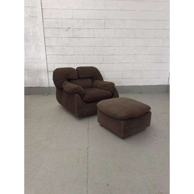 Brown fabric armchair and ottoman, attributed to Mario Marenco. Made in Italy, ca. 1970. This piece is attributed to the...