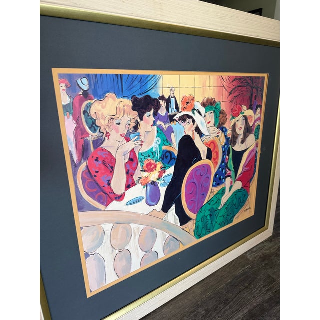 Vintage “Brunch at the Plaza” by M. Banks reproduction print featuring a lively and colorful café scene filled with...