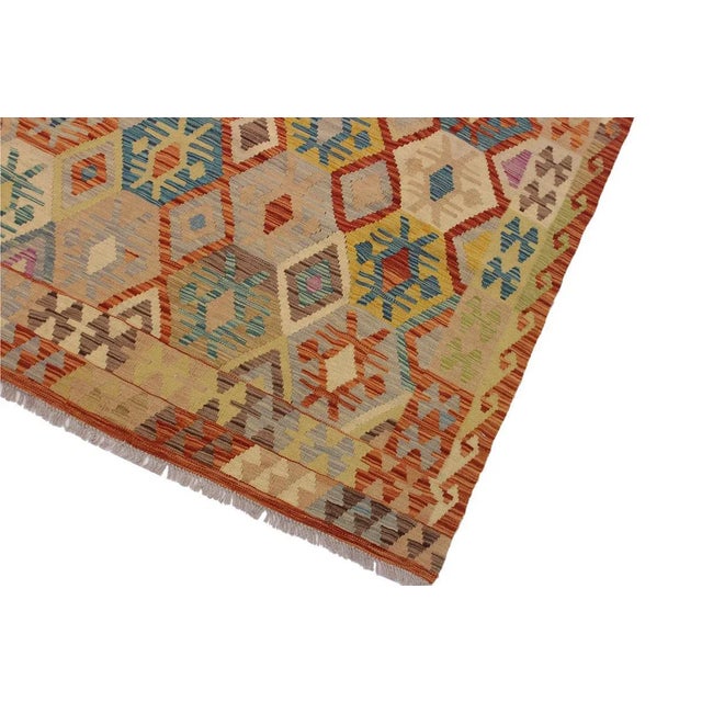 "Add a touch of elegance to your home with this casual chic hand woven Tribal Kilim wool rug. Constructed on a loom by...