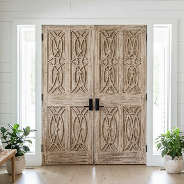 This striking pair of antique double entry doors is expertly hand-carved from solid wood and finished with a richly...