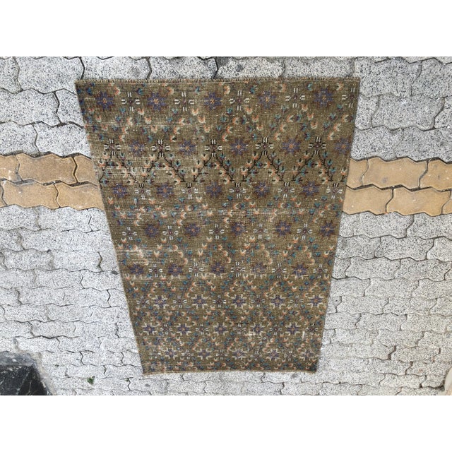 This is a vintage Turkish Oushak rug from the 1960s. The piece was hand-knotted.