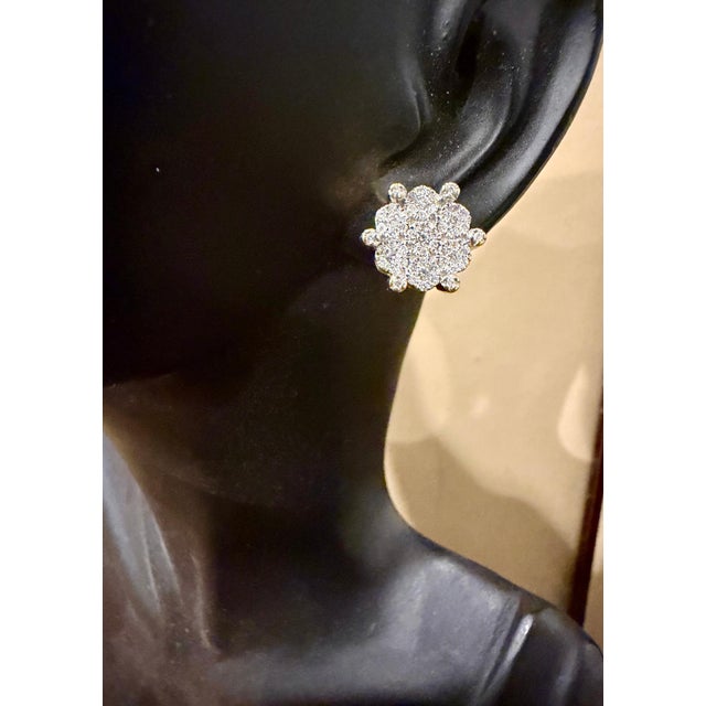 A sweet, shimmery style for any day of the week. These stud earrings blossom clusters of 1.8Ct. total diamond weight round...