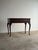 This antique mahogany lift-top writing desk combines the compact footprint of a narrow console table with a surprisingly...