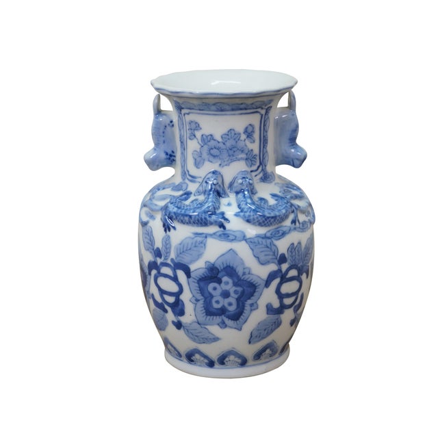Vintage Chinese porcelain vase decorated in a blue and white floral / dragon / foo dog motif, featuring distinctive...
